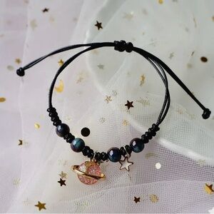Black Beaded Bracelet with Pink Planet Charm